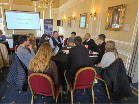 People sit around a table at the vascular meeting